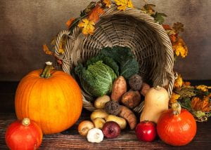 Fall vegetables spilling out of a cornucopia. 