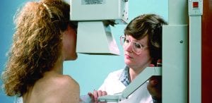 A woman receiving a mammogram at a clinic. DMS prof. H. Gilbert Welch argues that mammogram screenings might do less good for women that we believe.