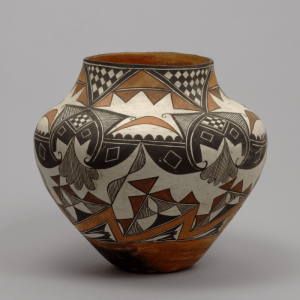 This image depicts a Southwest Acoma Pueblo Olla (water jar). It is made of terracotta, slip, and pigment. 
