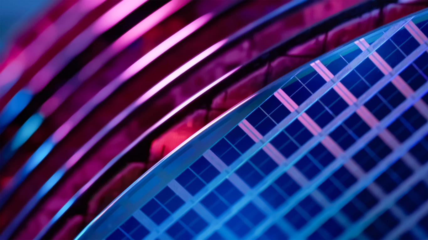 Macro of many silicon wafers with printed semiconductor chips in a wafer carrier box.